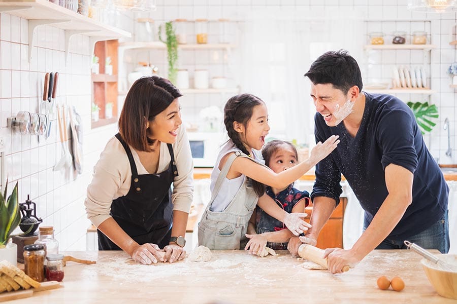 East Liverpool, OH - Family Enjoy Playing and Cooking Food in Kitchen at Home